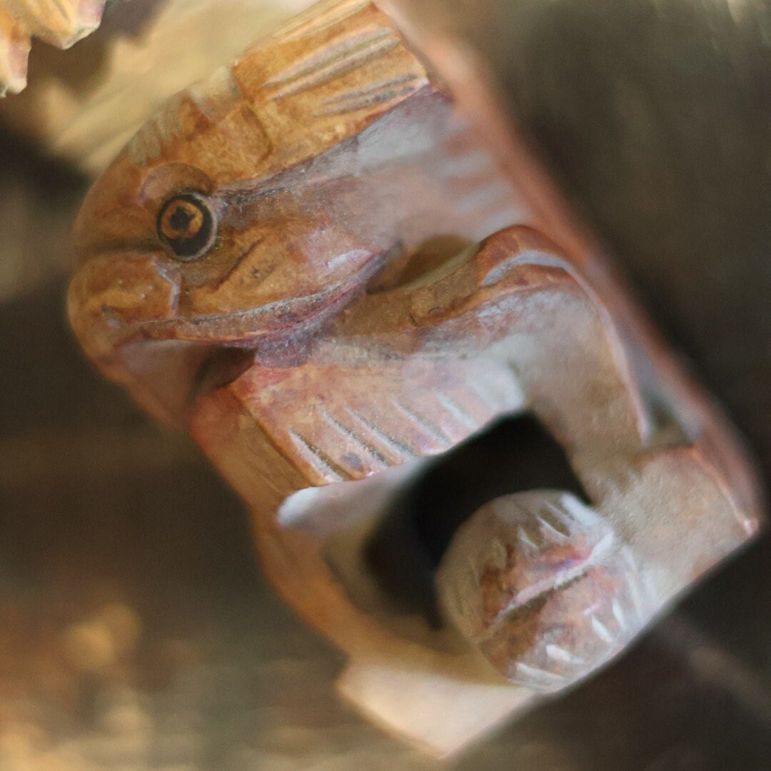 Seen from above, this 1950s hand-carved wooden lion figurine showcases a unique top-down perspective, highlighting the delicate textures and layered details on its mane and body. This angle emphasizes the craftsmanship and makes this piece an intriguing addition to any collection.