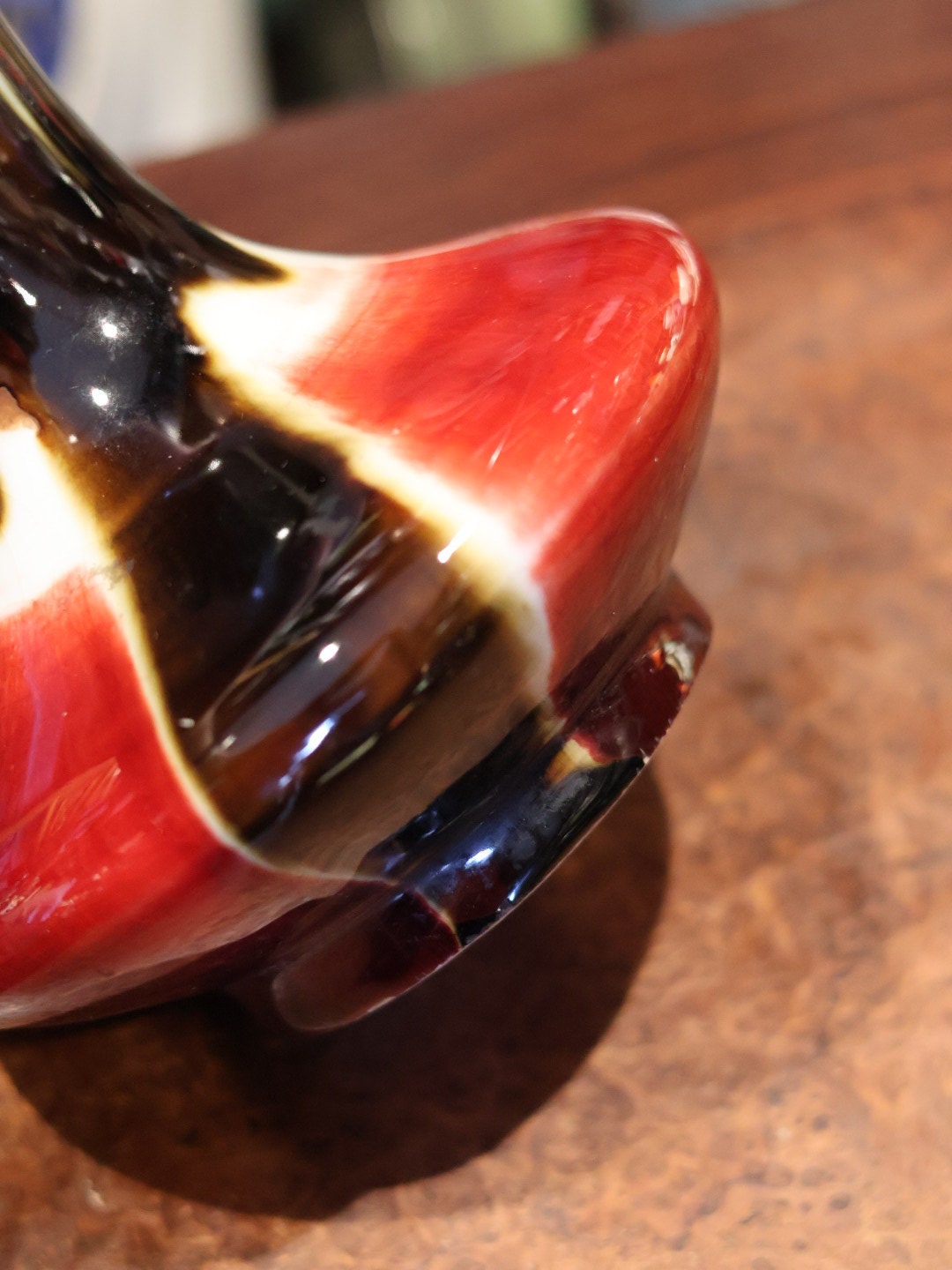 A close-up of the vase's base showcases the rich red glaze and smooth curves, a testament to the high-quality craftsmanship and glazing technique of Jingdezhen ceramics.