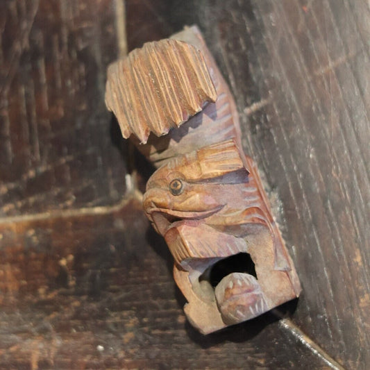 This side view captures the right profile of a rare 1950s hand-carved wooden Foo Dog (Lion) figurine. The intricate details, from the textured mane to the carefully etched lines, highlight the craftsmanship of this unique piece. Perfect for collectors seeking cultural and historical depth in vintage decor.