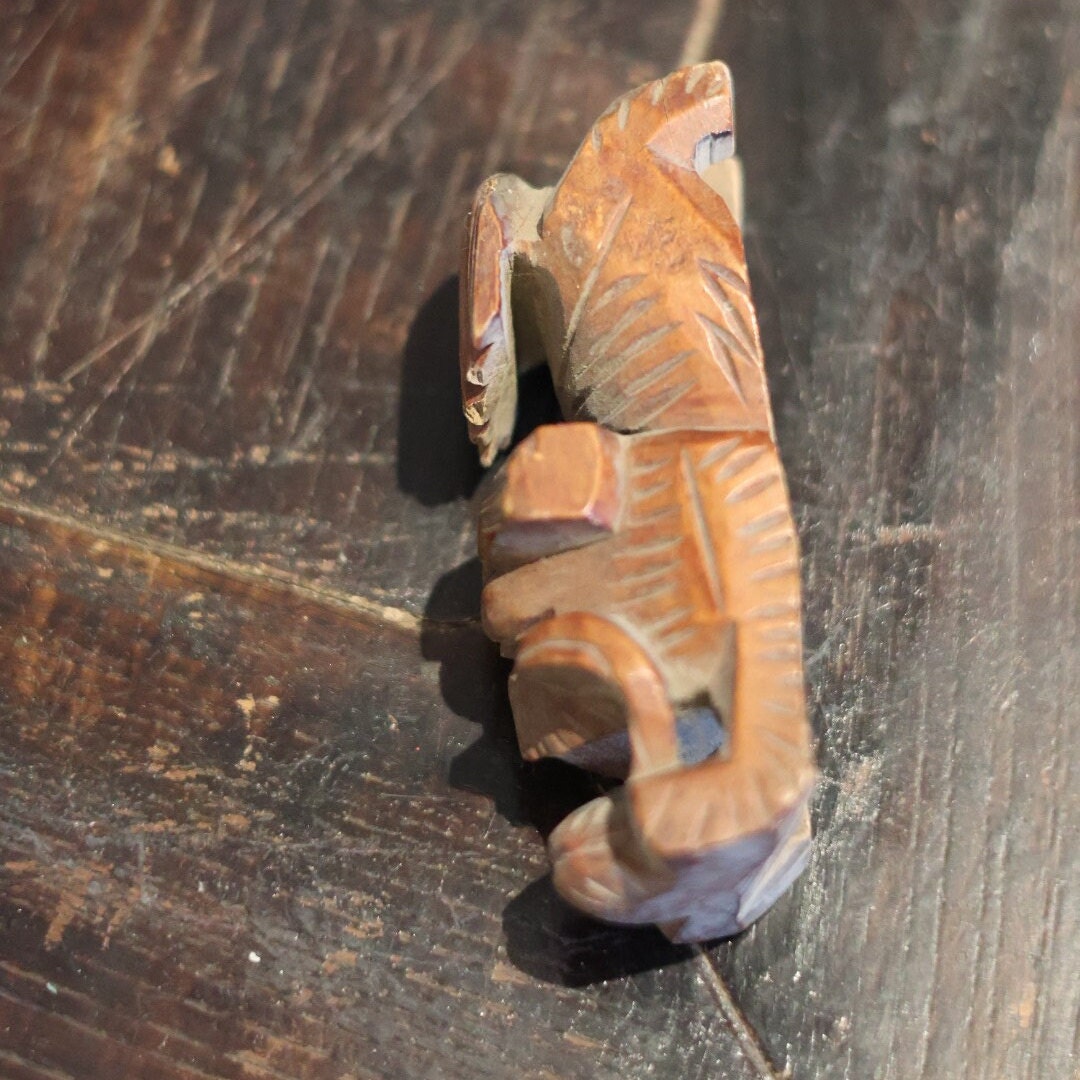 A closer look at the right side of this 1950s hand-carved wooden Foo Dog figurine. The rustic design and rich textures bring out the character and mystery of this collectible piece, showing unique carving details that emphasize its cultural significance.