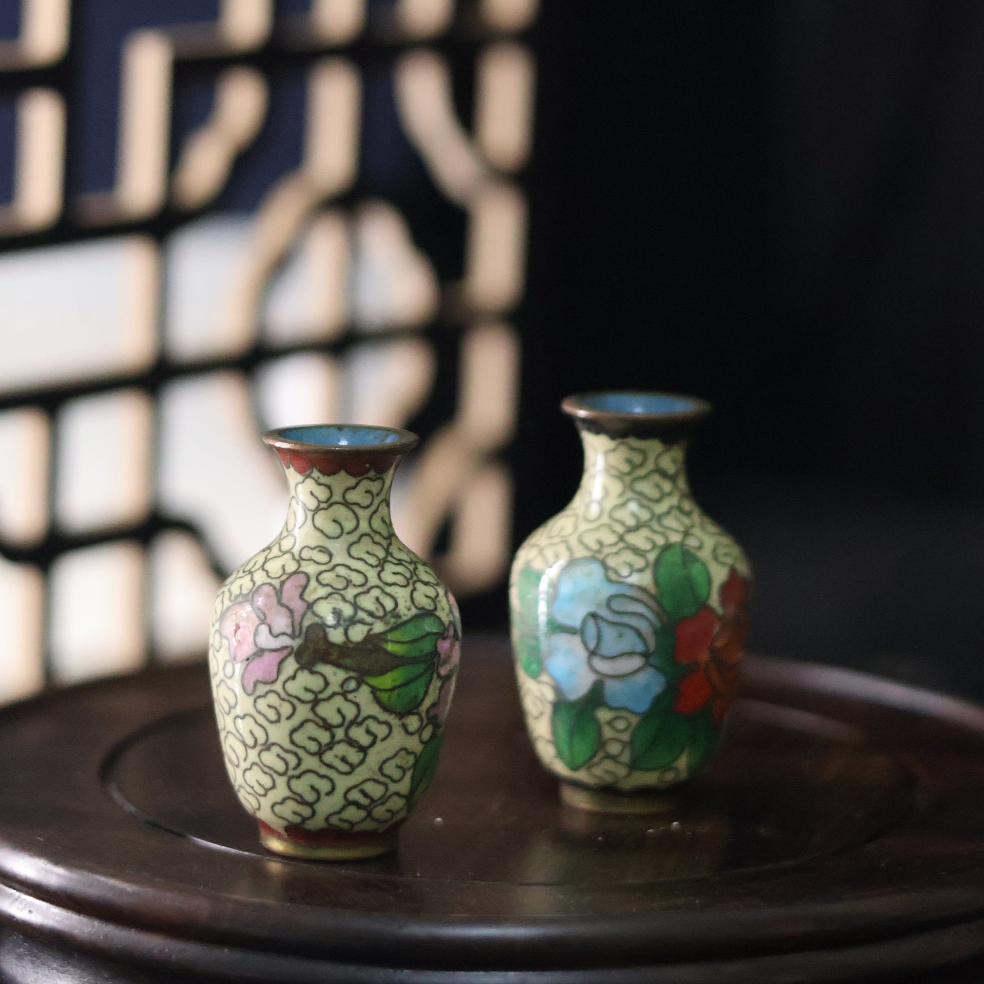 A petite pair of mid-century vases crafted in a cloisonné-style technique