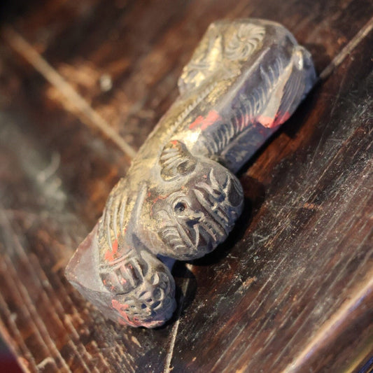 This unique hand-carved wooden Foo Dog figurine, shown from the lower left angle, highlights the craftsmanship details, including subtle red lacquer hints. Likely an ancient protective ornament from a Chinese door beam edge, it adds historical character.