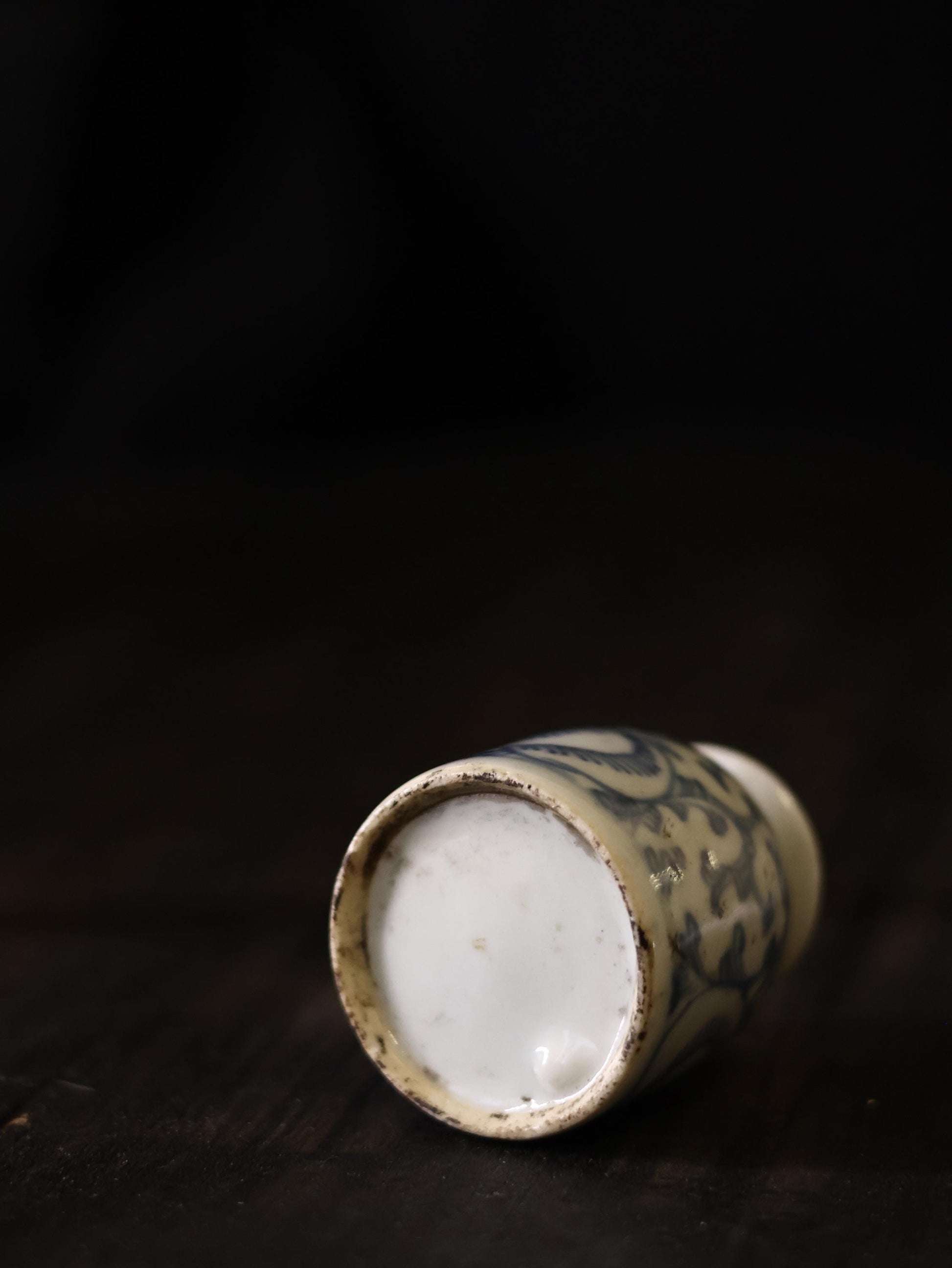 Displayed against a traditional Chinese background, this Qing Dynasty blue and white porcelain vase exudes an aura of elegance and heritage. The intricate patterns and aged appearance make it an exceptional addition for anyone passionate about antique Chinese ceramics.