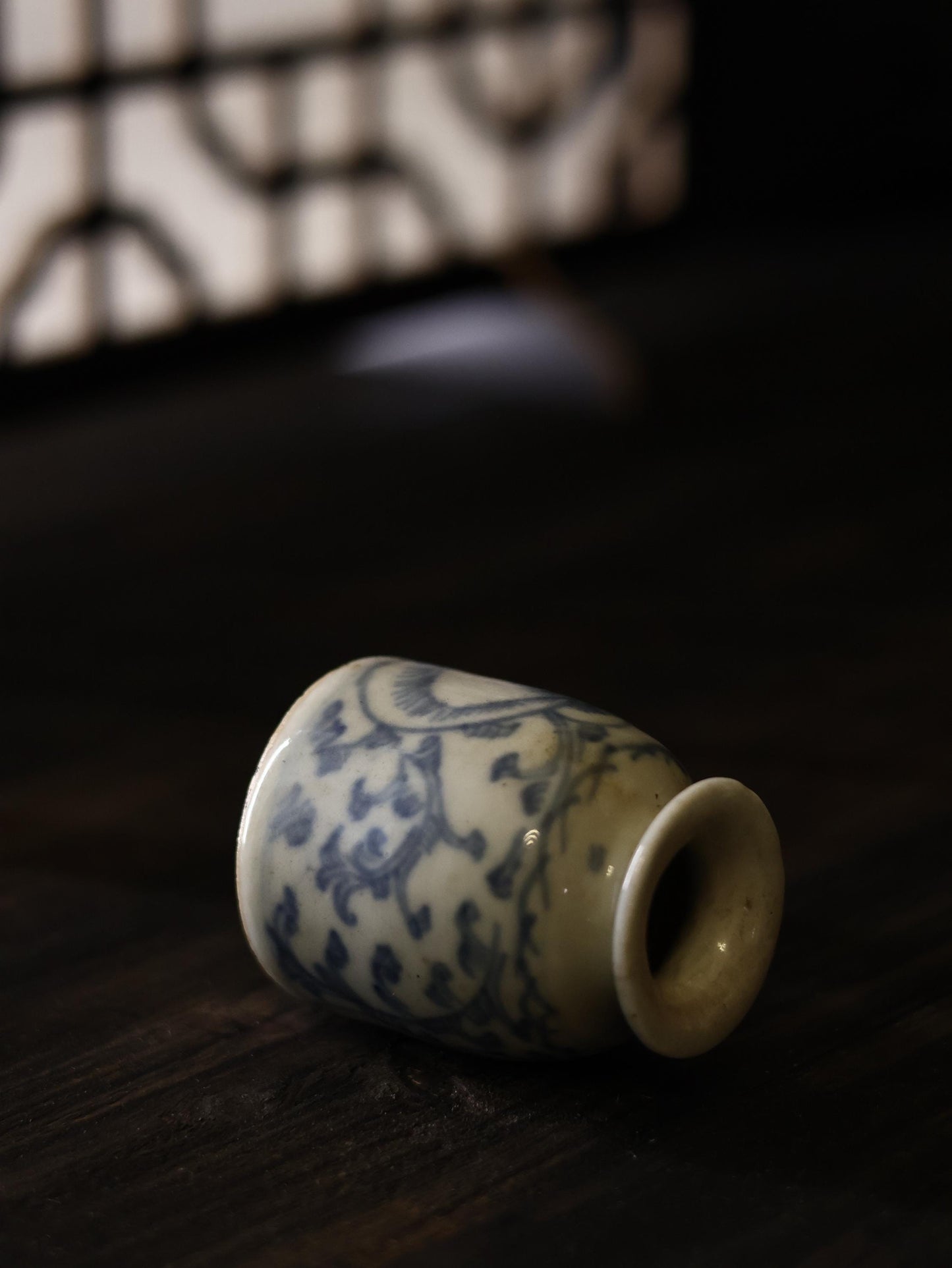 Featuring a slightly angled view, this antique Qing Dynasty vase exhibits the elegance of Chinese porcelain craftsmanship from the 18th century. The graceful shape and hand-painted blue floral designs make it a centerpiece for vintage and antique home decor.