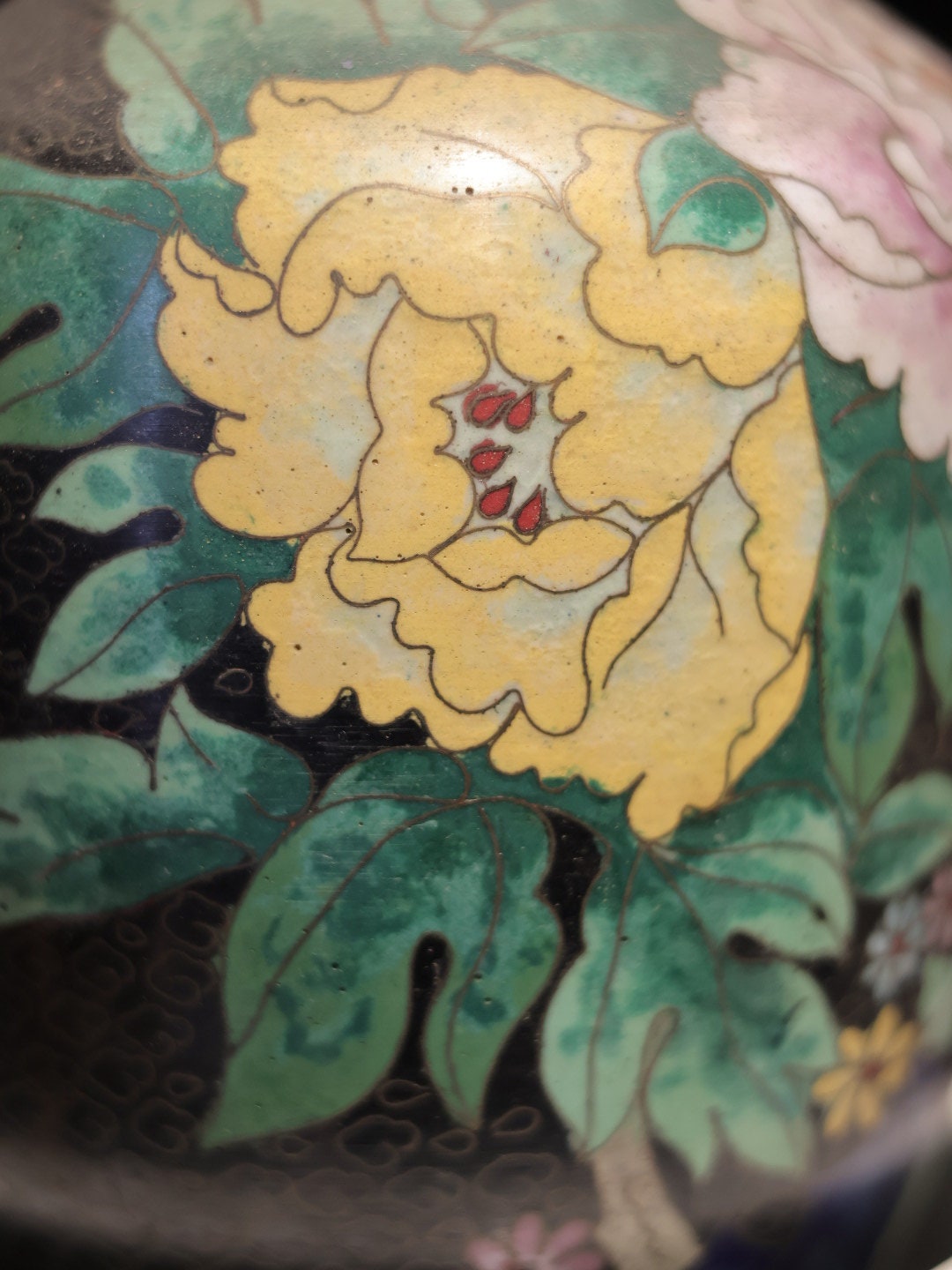 Focused view on a yellow floral motif, showcasing the precision of the hand-painted design.