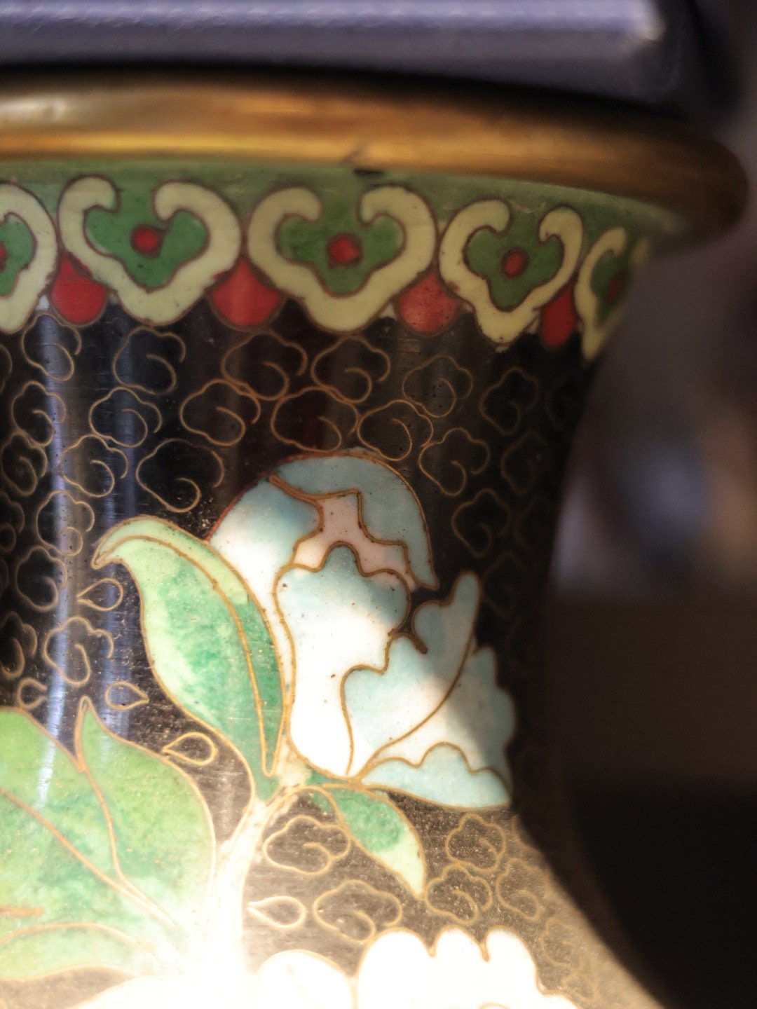 A close-up of the vase’s neck, showing detailed cloisonné patterns and vibrant colors in the enamel work.